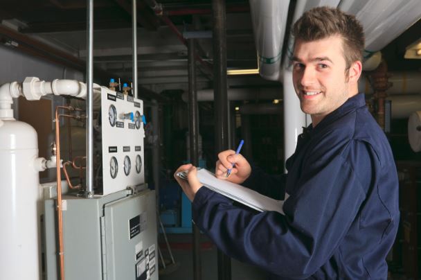Furnace installation technician servicing a heating system in Chesapeake, VA.