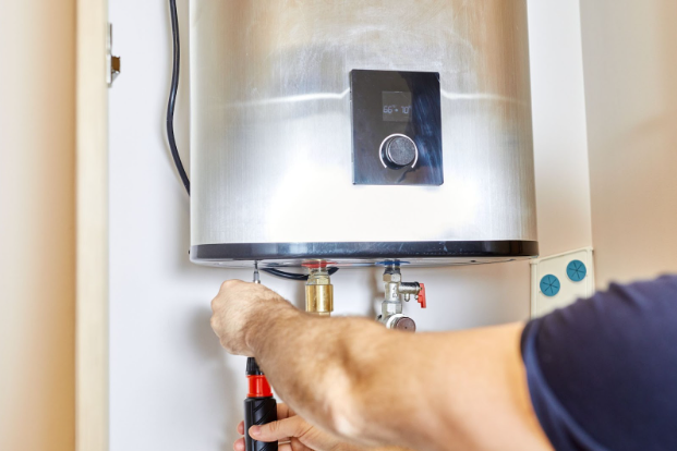 a man installs a water heater